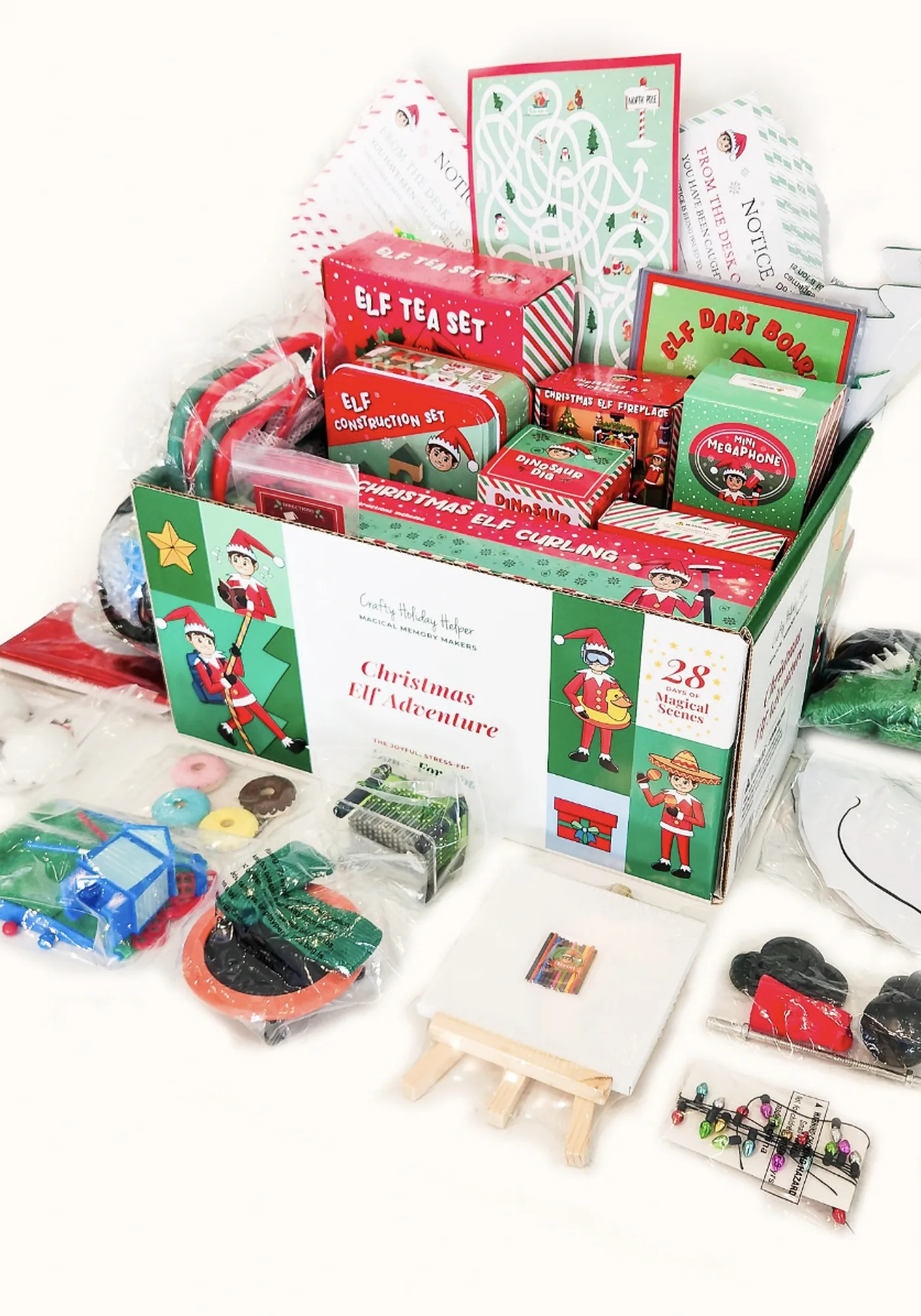 Holiday activity kit — open box with themed components on white