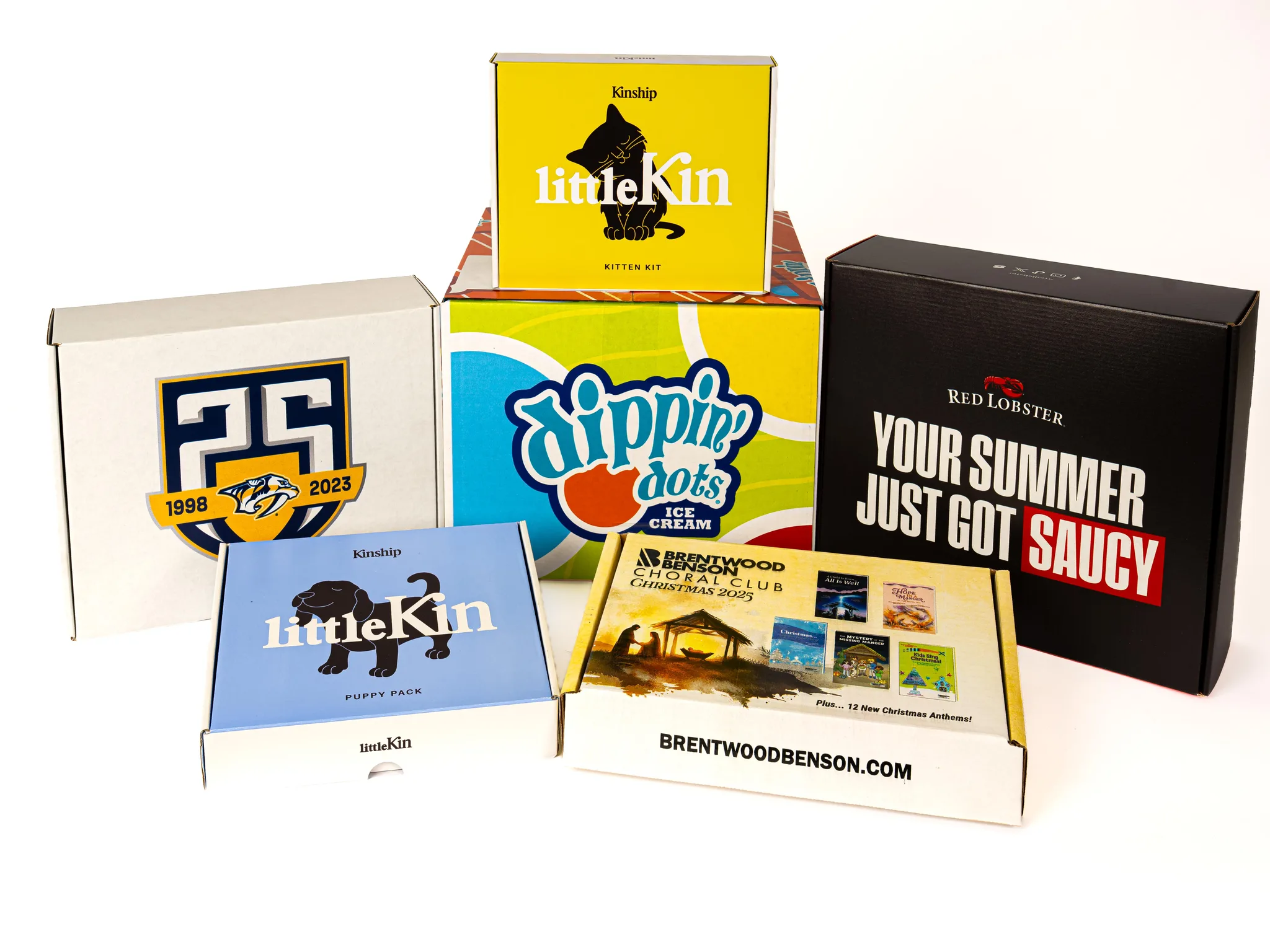 Lineup of six custom-printed kit boxes on white